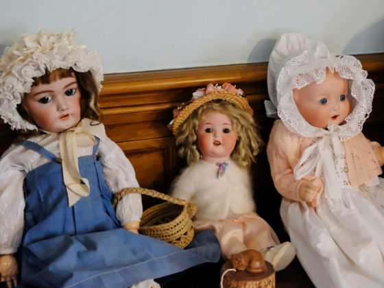 Antique dolls on a vintage bench